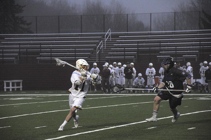 Junior midfielder Matt Fox looks upfield during a 12–6 home loss to the Kenyon College Lords on Wednesday. The loss dropped the team’s record to 5–7 and marked the Yeomen’s 19th consecutive loss against the Lords.