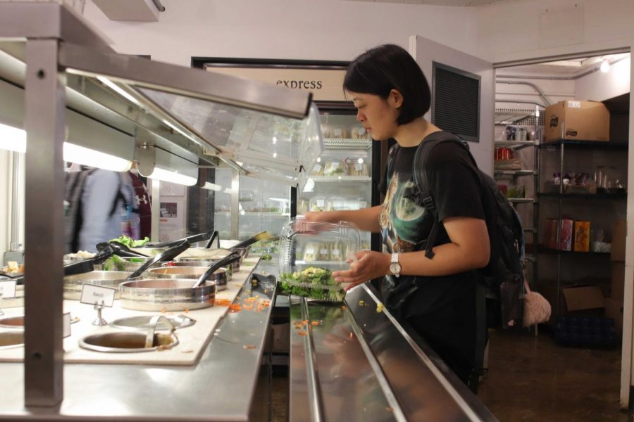 College Senior Andrea Wang grabs a salad at DeCafé’s new salad bar, one of the many changes to this year’s setup.