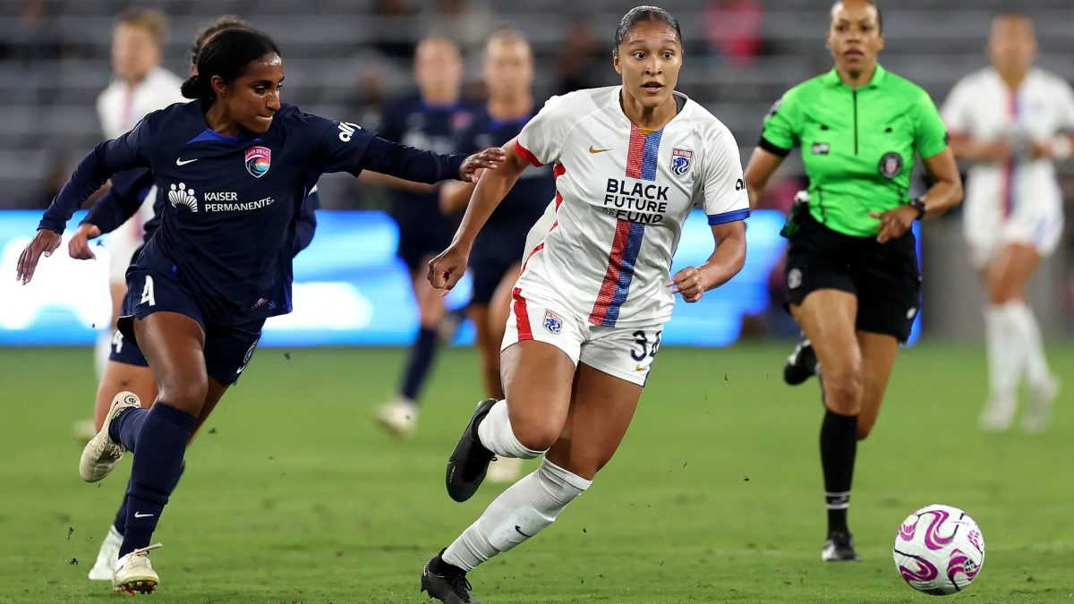 NWSL SD Wave defender Naomi Girma chases an OL Reign player.
